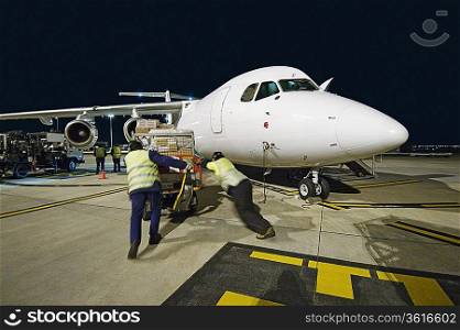 Airfreight loading onto BAE-146 at night.