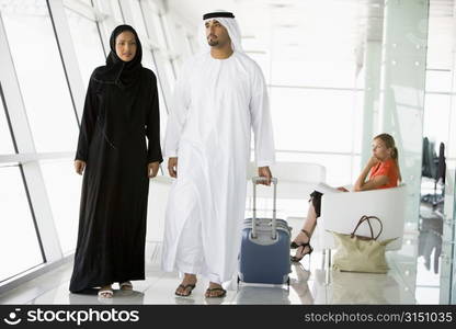 Airline passengers waiting in departure gate