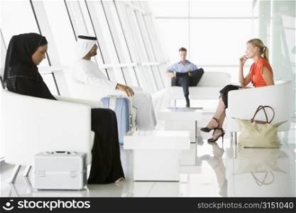 Airline passengers waiting in departure gate