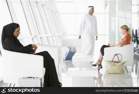 Airline passengers waiting in departure gate
