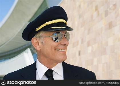 Airline pilot outside building, portrait, close up