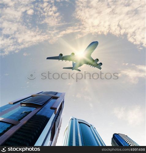 Airplane above city. Image of airplane flying above skyscrapers. Bottom view
