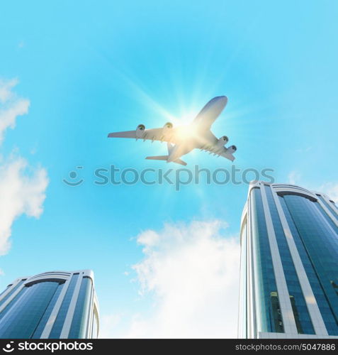 Airplane above city. Image of airplane flying above skyscrapers. Bottom view