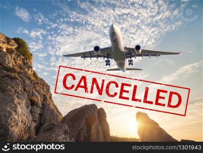 Airplane and flight cancellation. Canceled flights in Europe, Asia and USA airports. Travel cancelled. Pandemic of coronavirus. Fying passenger aircraft over the mountains at sunset and text. Covid-19