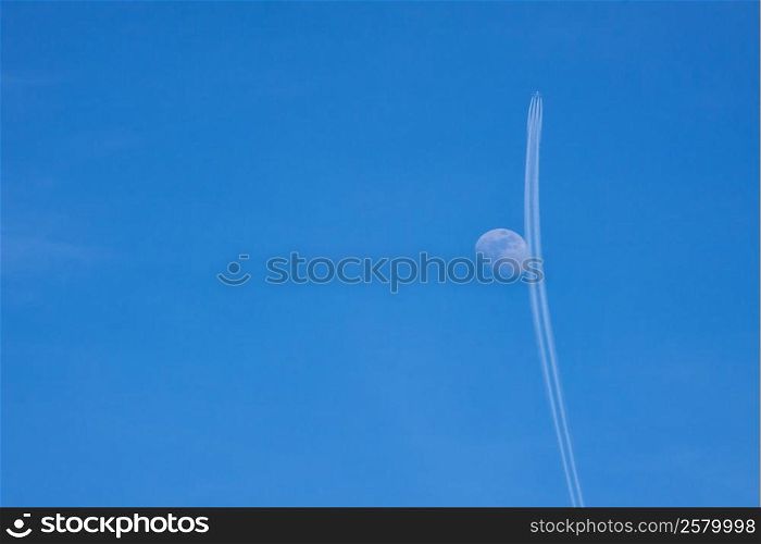 Airplane and moon in the sky