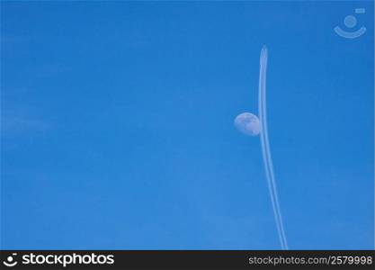 Airplane and moon in the sky