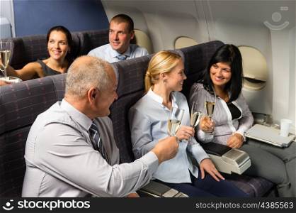 Airplane cabin businesspeople toasting with champagne flight travel passenger