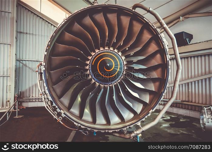 Airplane engine maintenance in airport hangar. Closeup view. Airplane engine maintenance