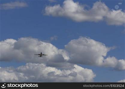 Airplane flies against a background of white cloud. Airplane flies against a background of white clouds