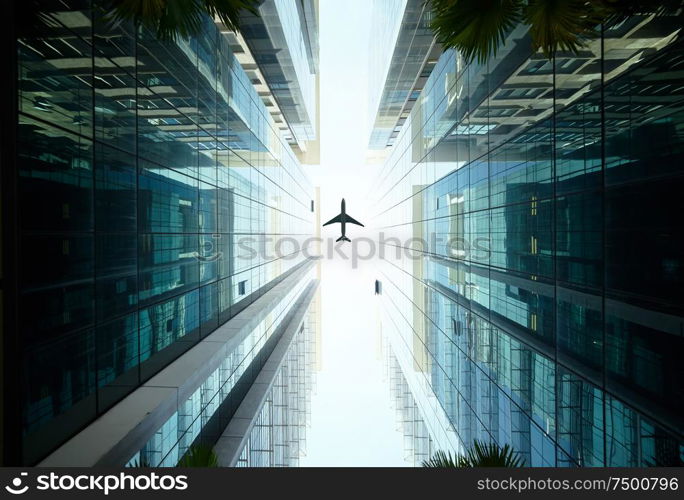 airplane flying above glass office buildings.