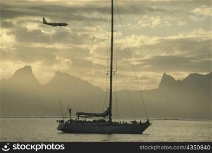 Airplane flying over a sailboat, Moorea, Tahiti, Society Islands, French Polynesia