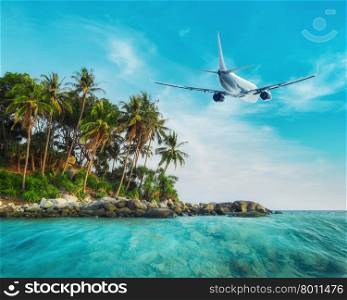 Airplane flying over amazing ocean landscape with tropical island. Thailand travel destinations