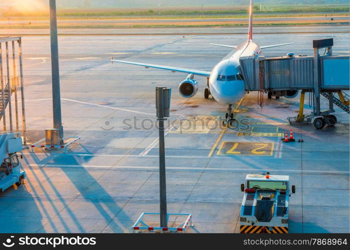 Airplane in airport before take-off at dawn