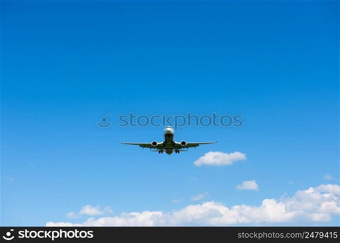 Airplane in blue sky front view from ground