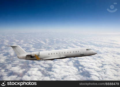 Airplane in flight over high altitude clouds