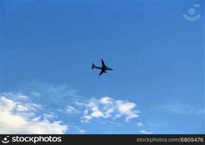Airplane in the blue sky with white clouds