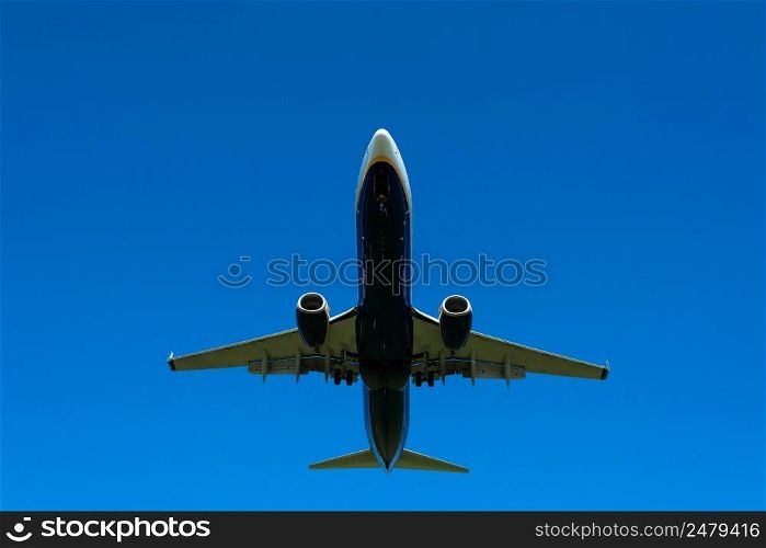 Airplane in the clear blue sky, preparing to landing