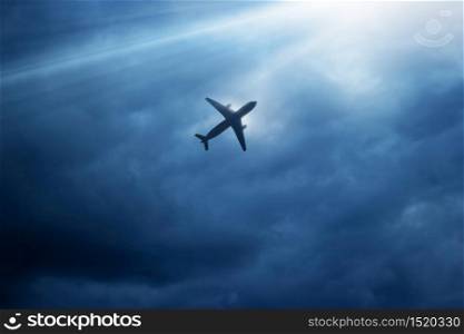 Airplane in the dark blue sky and cloud at strom