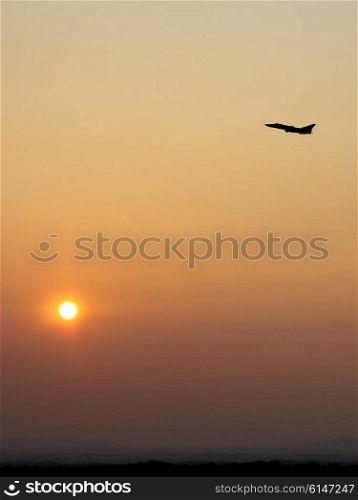 Airplane in the sky at sunrise. Silhouette airplane in the sky at sunrise