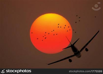 Airplane in the sky at sunset.. Airplane flying