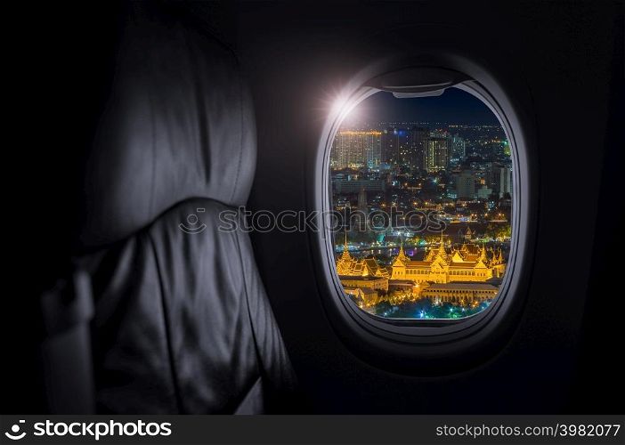 Airplane interior with window view of Grand Palace is actually a collection of structures in Rattanakosin, the historic center of Bangkok, Thailand, Concept of travel and air transportation.. Travel and transportation concept