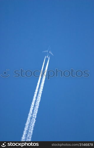 Airplane Leaving A Jet Stream In The Blue Sky