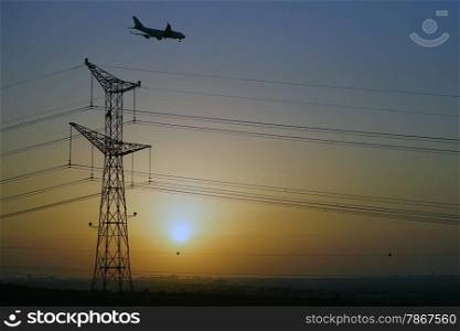 Airplane near electrical pylon and sunset, Israel