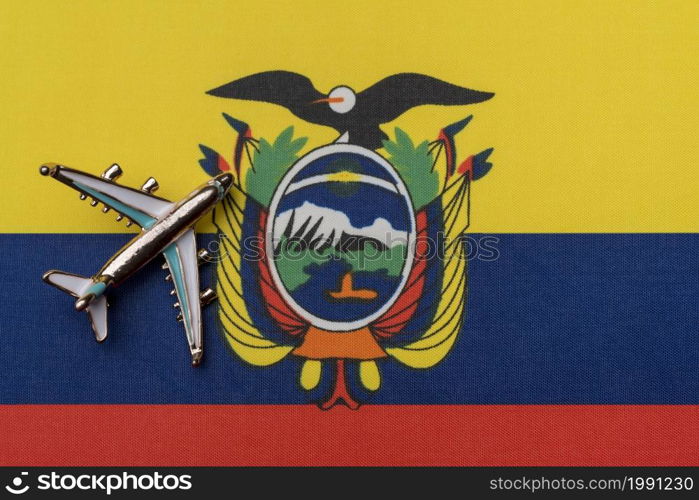 Airplane over Ecuador flag travel concept. Toy plane, tourism and travel.. Airplane over the flag of Ecuador travel concept.