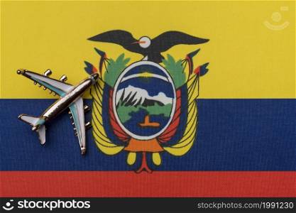 Airplane over Ecuador flag travel concept. Toy plane, tourism and travel.. Airplane over the flag of Ecuador travel concept.