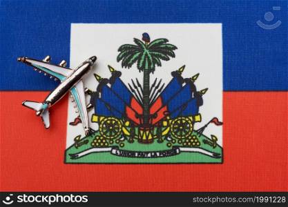 Airplane over Haiti flag travel concept. Toy plane, tourism and travel.. Samoletiki above flag Haiti travel concept in the country.