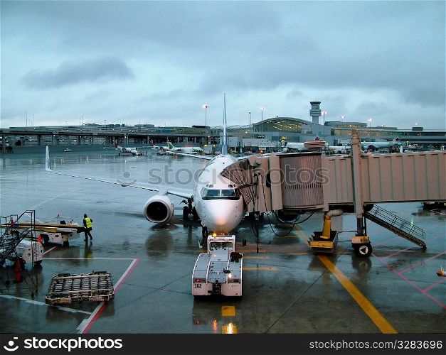 Airplane passenger jet loading at airport.