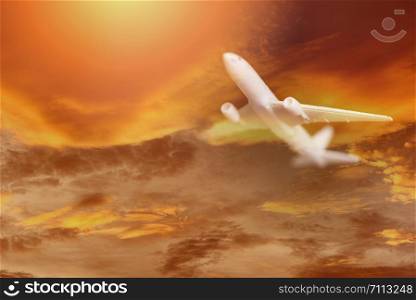 Airplane storm flying in the orange sky with clouds at colorful sunset Travel background / Traveler&rsquo;s Airlines plane dramatic sky and lightning flying at bad weather with red clouds