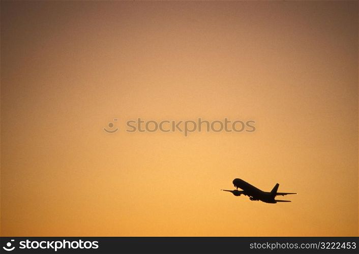 Airplane Taking off at Sunset
