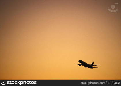 Airplane Taking off at Sunset