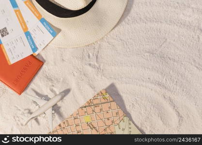airplane tickets with hat map sand