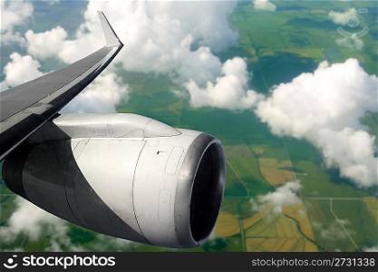 airplane wing aircraft turbine flying over agriculture fields