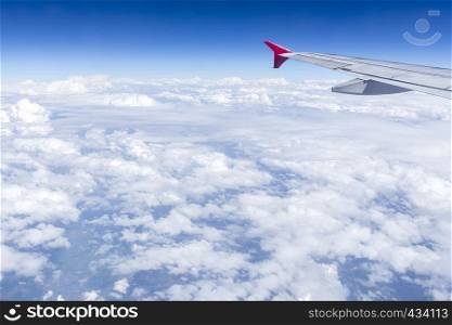 Airplane wing in the sky with cloud. Transportation, travel concept.