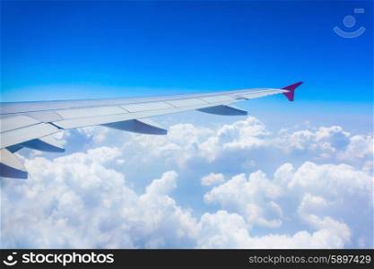 Airplane wing on the blue sky background