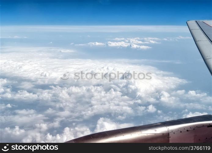 airplane wings in the blue clouds