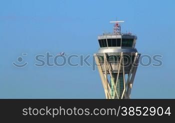 Airport control tower at full capacity.Radar control tower with an airplane across the sky.