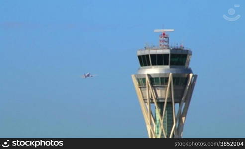 Airport control tower at full capacity.Radar control tower with an airplane across the sky.