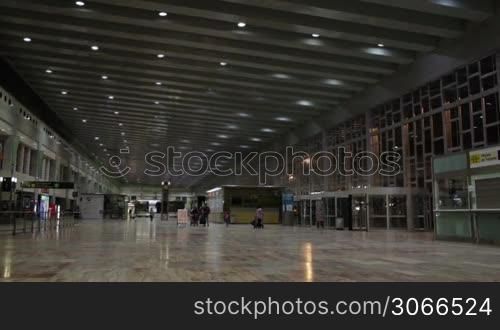 Airport hall with passengers.