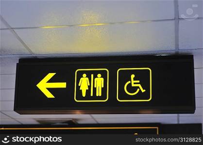 Airport toilet signs, yellow on black