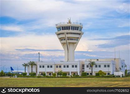Airport tower and building with cloudy skies