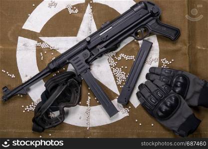 airsoft gun with protective glasses and a lot of bullets. airsoft gun with protective glasses and lot of bullets
