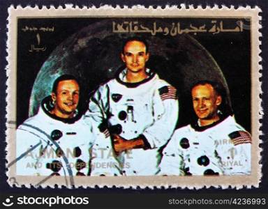 AJMAN - CIRCA 1973: a stamp printed in the Ajman shows Crew of Apollo 11, Neil Armstrong, Buzz Aldrin and Michael Collins, Moon-landing, Apollo 11, circa 1973