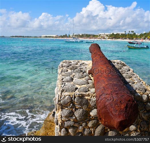 Akumal beach rusted iron canon in Riviera Maya of Mayan Mexico