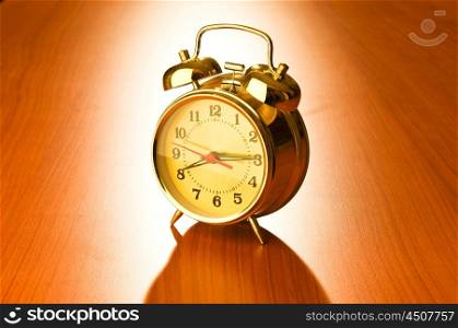 Alarm clock against wooden background