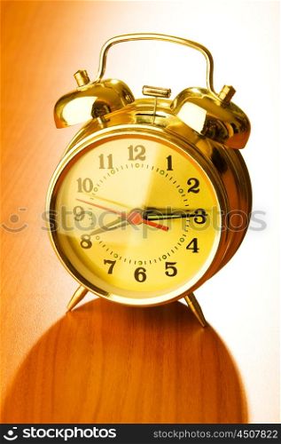 Alarm clock against wooden background
