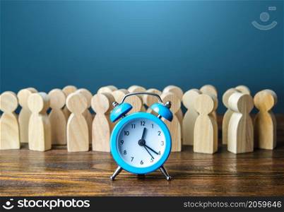 Alarm clock and a crowd of people. Time management. Hourly wages, strict work limits and break time. Planning and forecasting. Employee performance monitoring system, Organization of business